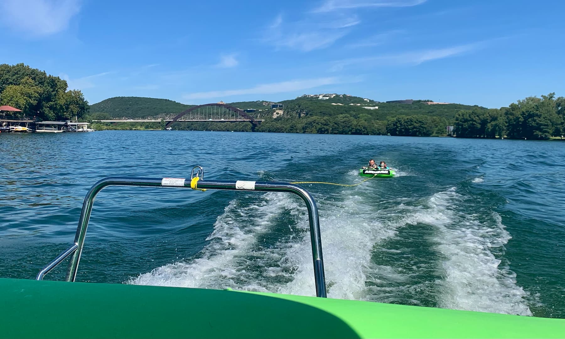 My kids riding in a tube behind a boat on Lake Austin with the famous Pennybacker bridge in the background.